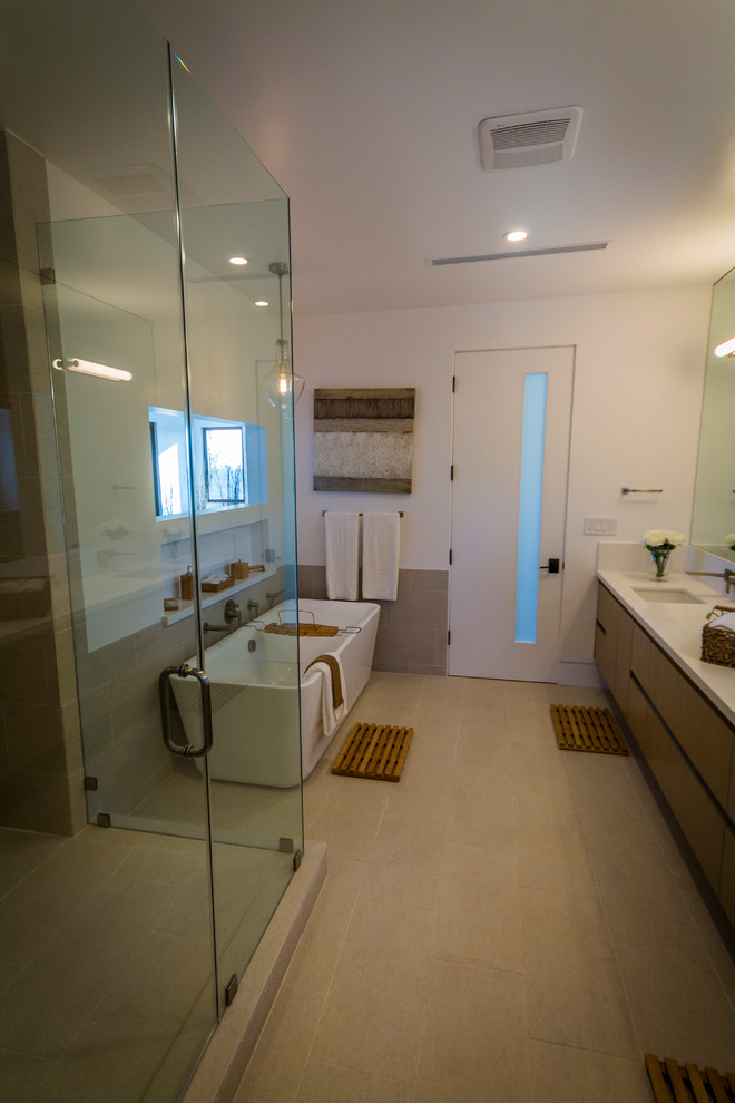 Large midcentury ensuite bathroom in Los Angeles with flat-panel cabinets, dark wood cabinets, a freestanding bath, a corner shower, multi-coloured tiles, ceramic tiles, white walls, ceramic flooring, a built-in sink and laminate worktops.