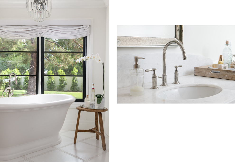 Идея дизайна: большая главная ванная комната в классическом стиле с фасадами островного типа, фасадами цвета дерева среднего тона, отдельно стоящей ванной, белой плиткой, мраморным полом, врезной раковиной, мраморной столешницей, белым полом и белой столешницей