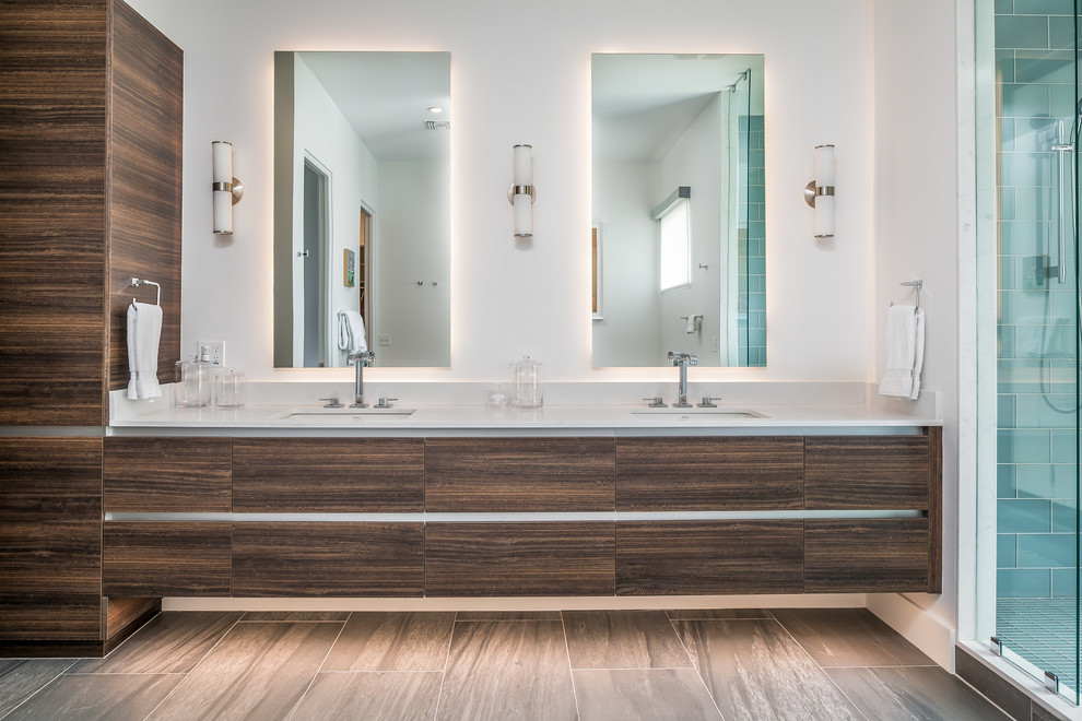 Example of a large trendy master gray tile brown floor alcove shower design in Phoenix with flat-panel cabinets, dark wood cabinets, an undermount sink, quartz countertops, white countertops and white walls