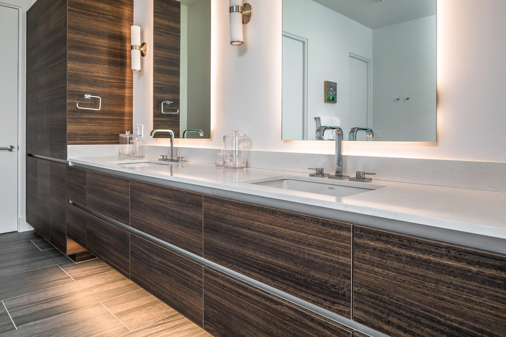 Large contemporary ensuite bathroom in Phoenix with flat-panel cabinets, dark wood cabinets, grey tiles, grey walls, light hardwood flooring, a submerged sink, engineered stone worktops, brown floors and white worktops.