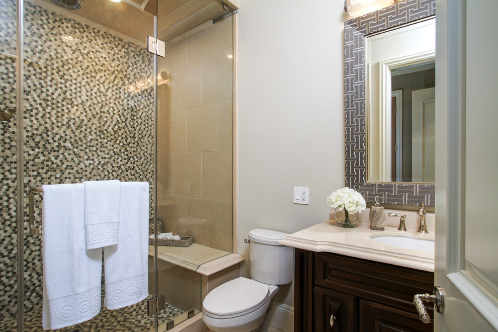 Idées déco pour une salle de bain classique en bois brun de taille moyenne avec un lavabo encastré, un placard avec porte à panneau surélevé, un plan de toilette en marbre, WC séparés, un carrelage beige, mosaïque, un mur beige et un sol en marbre.