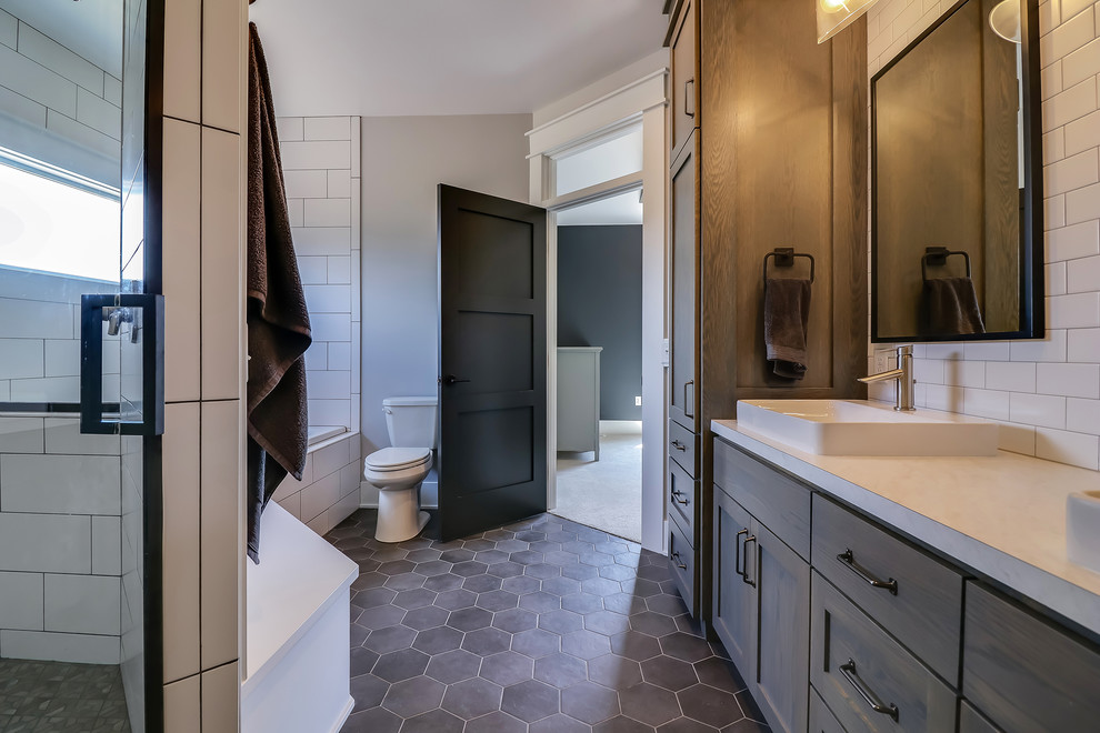 Bathroom - large contemporary master white tile and subway tile porcelain tile and black floor bathroom idea in Grand Rapids with shaker cabinets, distressed cabinets, a two-piece toilet, gray walls, a vessel sink, quartzite countertops, a hinged shower door and white countertops