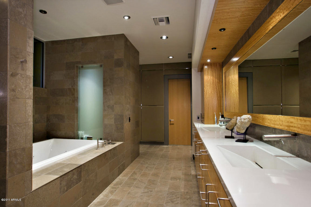 Large minimalist master gray tile and stone tile bathroom photo in Phoenix with an integrated sink, flat-panel cabinets, medium tone wood cabinets, a one-piece toilet and white walls