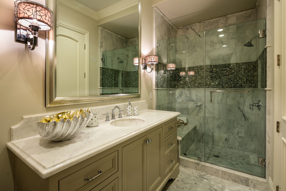 Photo of a medium sized classic bathroom in Los Angeles with a built-in sink, raised-panel cabinets, brown cabinets, marble worktops, a built-in bath, a two-piece toilet, white tiles, stone tiles, beige walls and marble flooring.