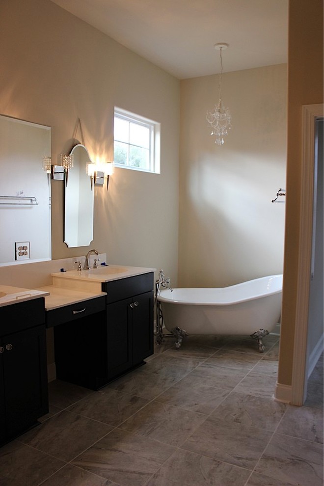 Example of a mid-sized minimalist gray tile ceramic tile claw-foot bathtub design in Wilmington with an integrated sink, marble countertops and beige walls