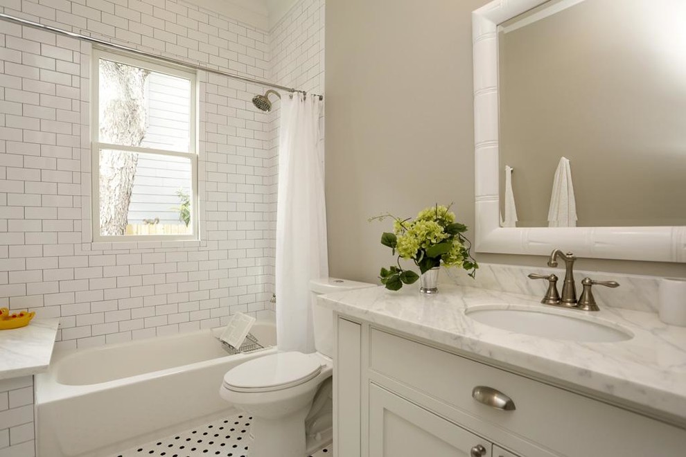 This is an example of a medium sized traditional shower room bathroom in Denver with a submerged sink, shaker cabinets, white cabinets, marble worktops, an alcove bath, a shower/bath combination, a two-piece toilet, white tiles, ceramic tiles, grey walls and porcelain flooring.