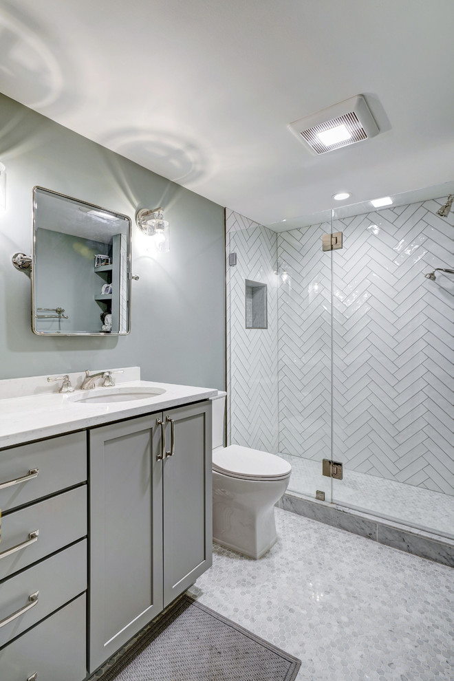 Medium sized classic ensuite bathroom in DC Metro with shaker cabinets, grey cabinets, an alcove shower, a two-piece toilet, white tiles, ceramic tiles, green walls, marble flooring, a submerged sink, engineered stone worktops, multi-coloured floors, a hinged door and white worktops.