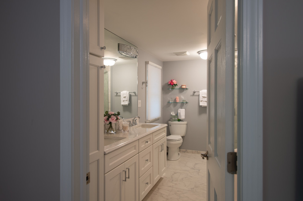 Photo of a medium sized bohemian ensuite bathroom in Chicago with recessed-panel cabinets, white cabinets, a freestanding bath, a double shower, a two-piece toilet, multi-coloured tiles, porcelain tiles, grey walls, porcelain flooring, a submerged sink, engineered stone worktops, multi-coloured floors, a hinged door and multi-coloured worktops.