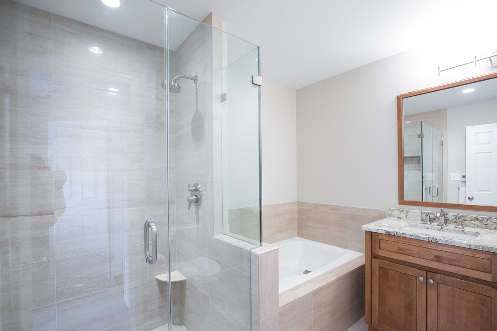 Example of a small transitional master beige tile and ceramic tile ceramic tile bathroom design in DC Metro with an undermount sink, shaker cabinets, medium tone wood cabinets, granite countertops, a two-piece toilet and beige walls