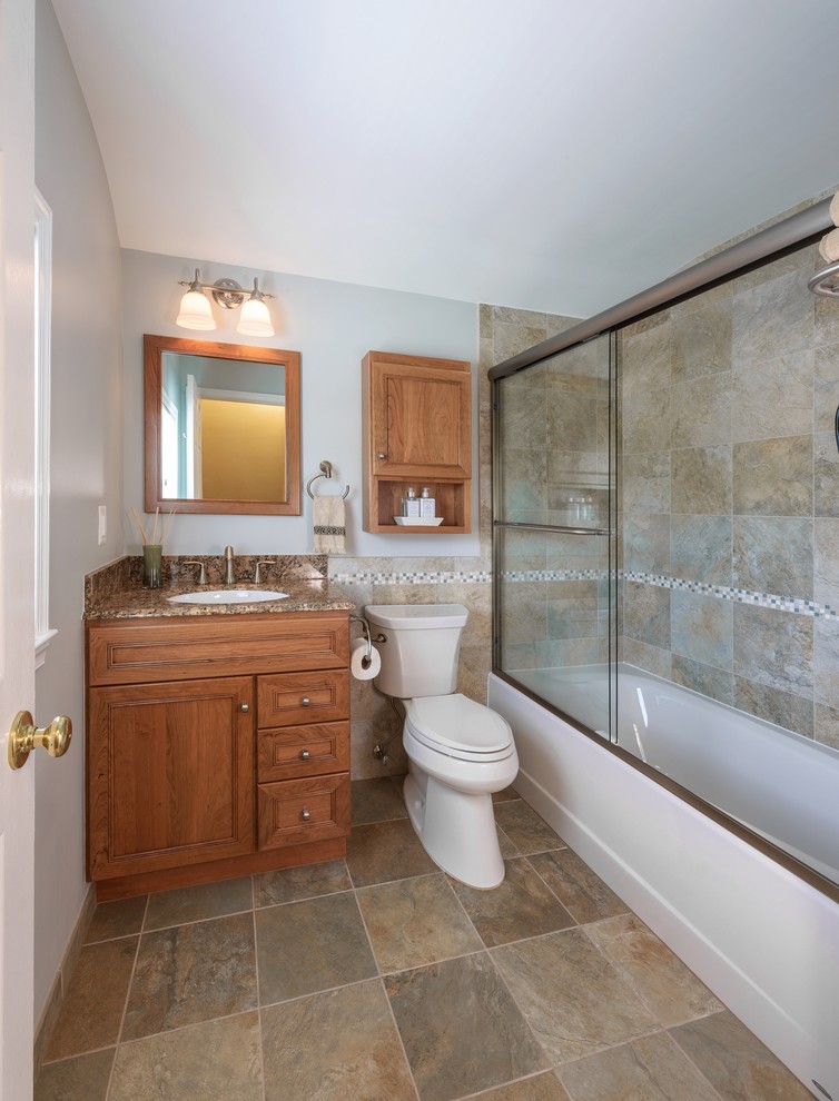 Example of a small transitional 3/4 brown tile and ceramic tile ceramic tile bathroom design in DC Metro with an undermount sink, beaded inset cabinets, medium tone wood cabinets, granite countertops, a two-piece toilet and beige walls