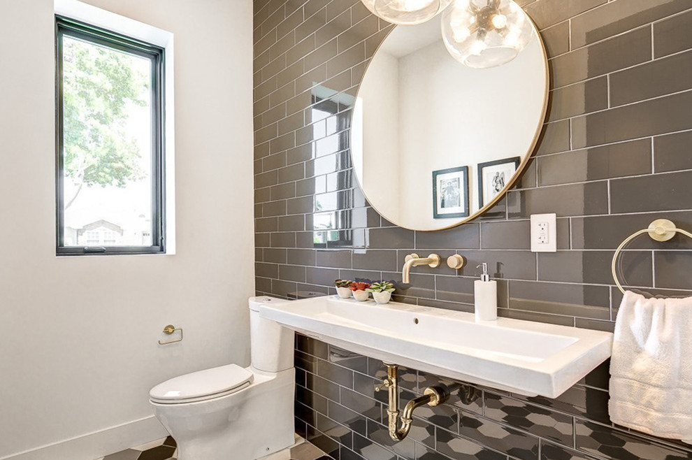 Inspiration for a mid-sized modern 3/4 gray tile and subway tile ceramic tile and multicolored floor bathroom remodel in Los Angeles with a two-piece toilet, gray walls, a trough sink and solid surface countertops