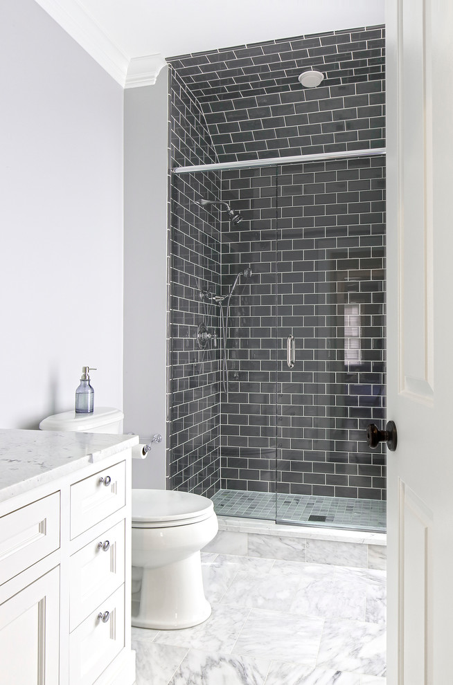 Large transitional kids' gray tile and glass tile marble floor alcove shower photo in New York with an undermount sink, furniture-like cabinets, white cabinets, marble countertops, a two-piece toilet and gray walls