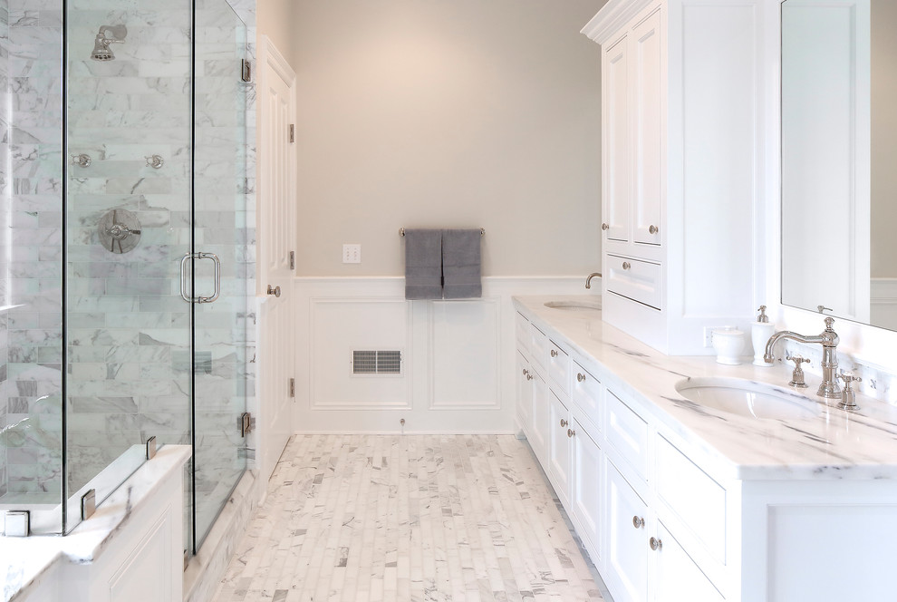 Expansive classic ensuite bathroom in New York with a submerged sink, freestanding cabinets, white cabinets, marble worktops, a built-in bath, a double shower, a two-piece toilet, multi-coloured tiles, stone tiles, grey walls and marble flooring.