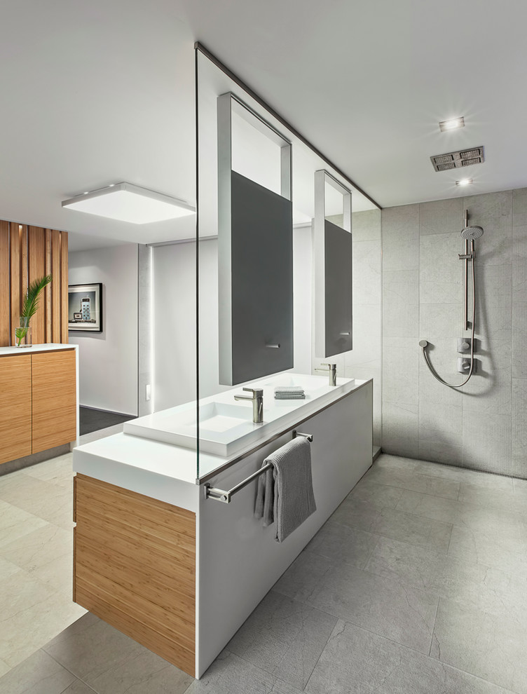 Inspiration for a contemporary gray tile alcove shower remodel in Toronto with a vessel sink, flat-panel cabinets and medium tone wood cabinets