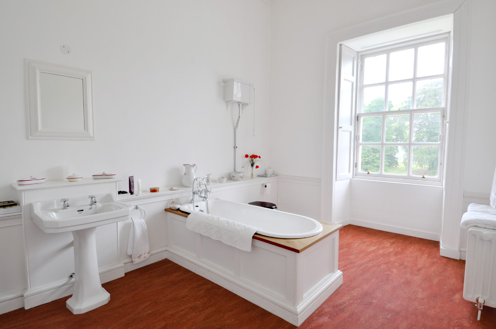 Inspiration for a large traditional bathroom in Edinburgh with a shower/bath combination, a one-piece toilet, white walls, lino flooring and a pedestal sink.