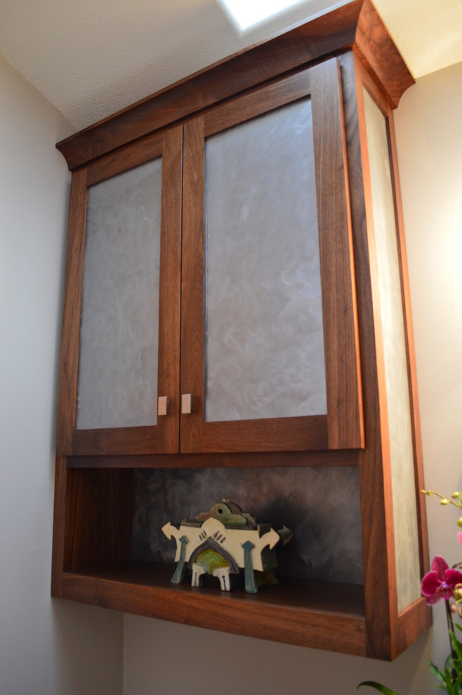 Arnold over the toilet in walnut with brushed steel door panels