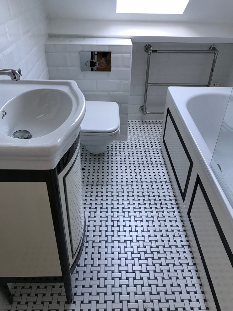 Bathroom - mid-sized contemporary kids' ceramic tile mosaic tile floor and white floor bathroom idea in London with furniture-like cabinets, white cabinets, a one-piece toilet, white walls and a wall-mount sink