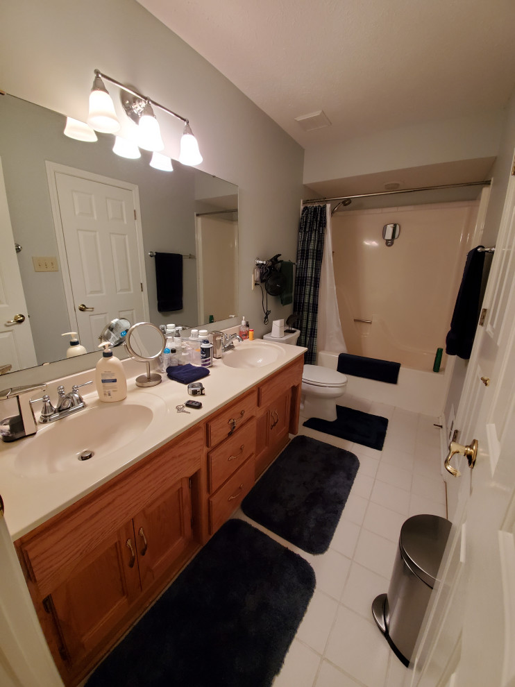 Small traditional family bathroom in Indianapolis with raised-panel cabinets, white cabinets, an alcove bath, a shower/bath combination, grey tiles, ceramic tiles, grey walls, mosaic tile flooring, a submerged sink, marble worktops, multi-coloured floors, white worktops, double sinks and a freestanding vanity unit.