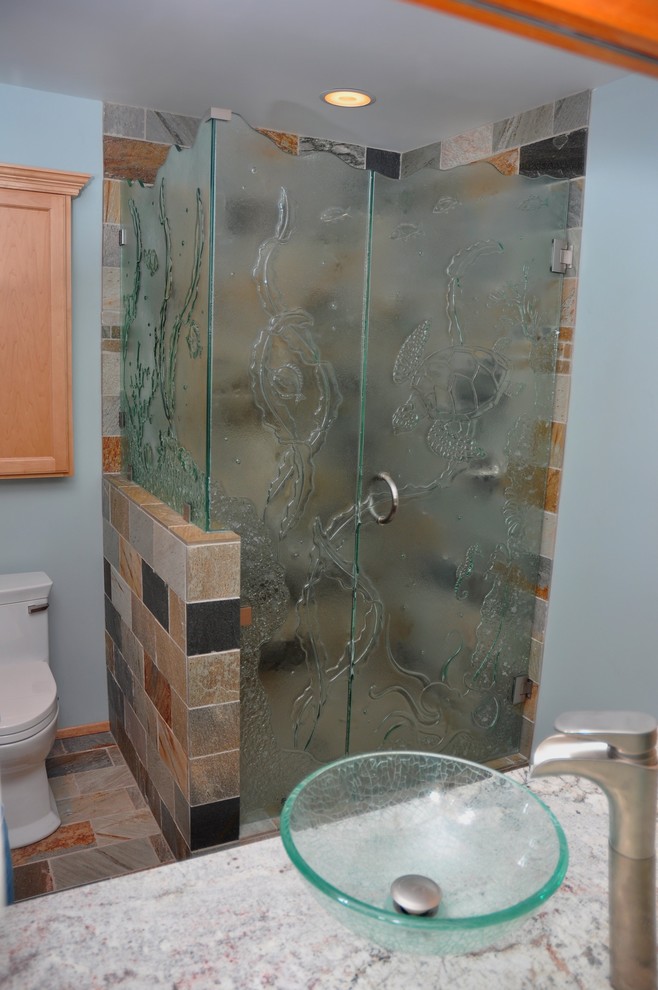 Inspiration for a small transitional stone tile slate floor corner shower remodel in Seattle with a vessel sink, recessed-panel cabinets, light wood cabinets, granite countertops and blue walls