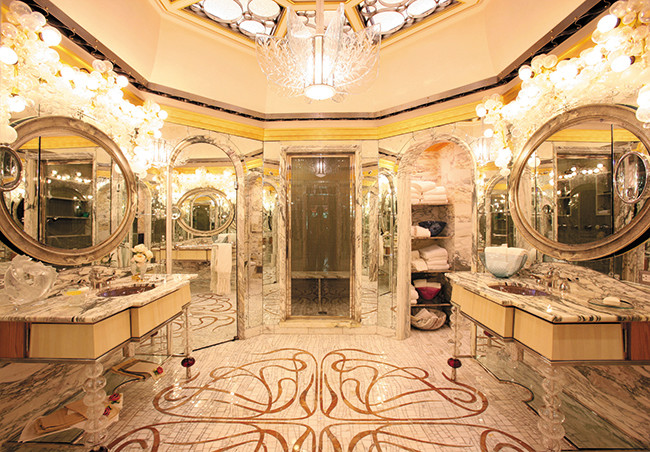 This is an example of an expansive bohemian ensuite bathroom in San Francisco with freestanding cabinets, beige cabinets, an alcove shower, a two-piece toilet, multi-coloured walls, marble flooring, a submerged sink and marble worktops.