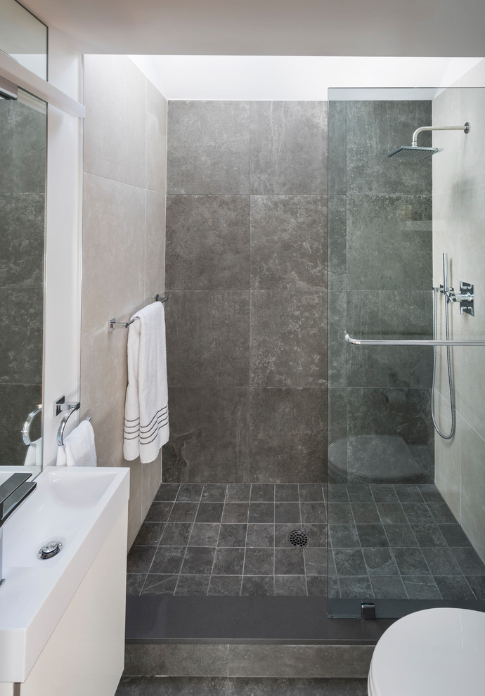 Design ideas for a medium sized contemporary shower room bathroom in Boston with flat-panel cabinets, white cabinets, a walk-in shower, beige tiles, grey tiles, porcelain tiles, white walls, porcelain flooring, an integrated sink, grey floors and a hinged door.