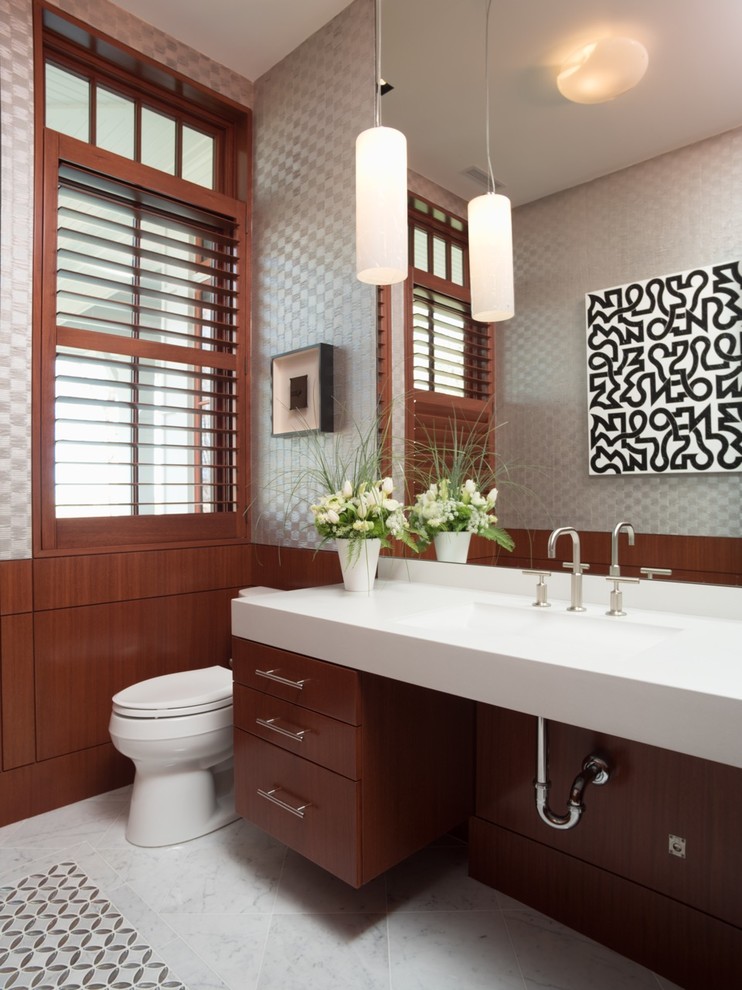 Exemple d'une salle de bain tendance en bois brun avec un placard à porte plane, un mur gris, un lavabo intégré et une fenêtre.
