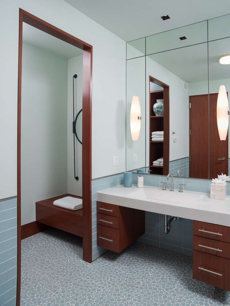 Inspiration for a contemporary bathroom in Boston with flat-panel cabinets, medium wood cabinets, blue tiles, blue walls and an integrated sink.