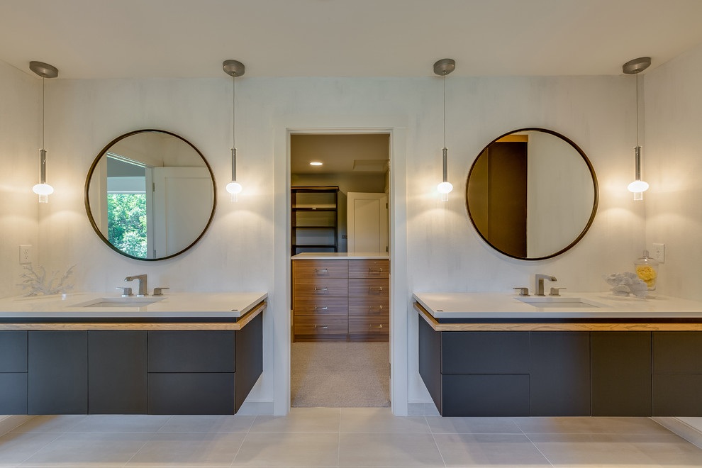 Large traditional ensuite bathroom in Minneapolis with flat-panel cabinets, black cabinets, a freestanding bath, an alcove shower, white tiles, ceramic tiles, white walls, cement flooring, a submerged sink, engineered stone worktops, grey floors, an open shower and white worktops.