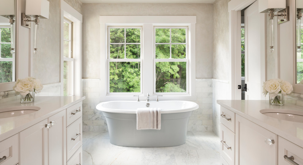 Example of a mid-sized transitional master white tile and marble tile marble floor and white floor bathroom design in Minneapolis with recessed-panel cabinets, white cabinets, a one-piece toilet, gray walls, a drop-in sink and quartzite countertops