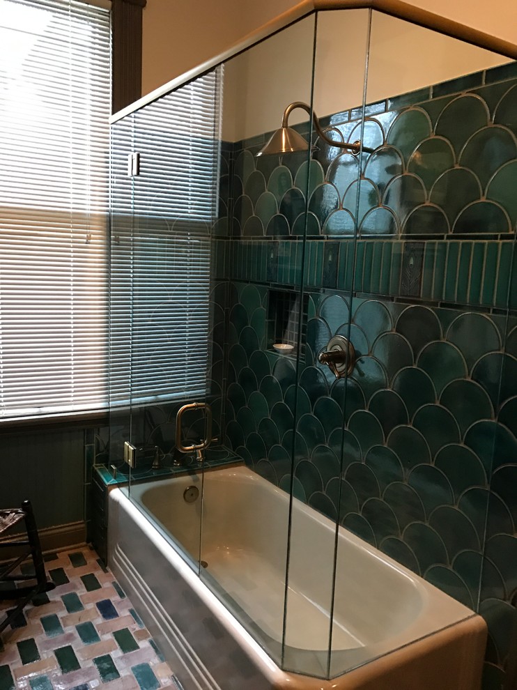 Medium sized traditional ensuite bathroom in Nashville with freestanding cabinets, a freestanding bath, a shower/bath combination, a wall mounted toilet, blue tiles, green tiles, multi-coloured tiles, ceramic tiles, multi-coloured walls, porcelain flooring, marble worktops, multi-coloured floors, a hinged door, grey cabinets and a submerged sink.
