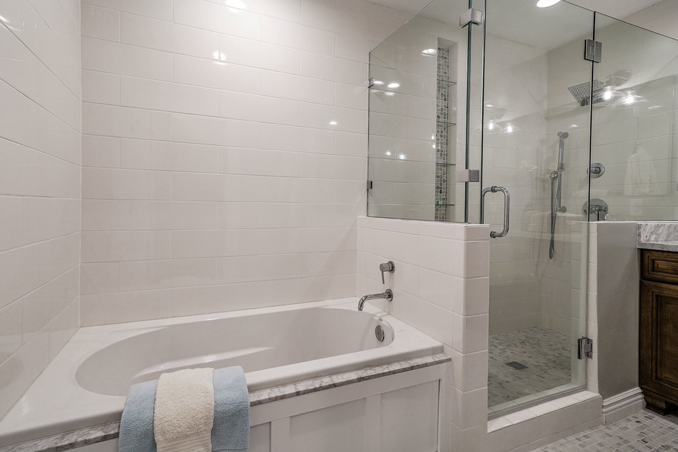 This is an example of a medium sized traditional ensuite bathroom in San Francisco with raised-panel cabinets, dark wood cabinets, a built-in bath, a corner shower, white tiles, metro tiles, grey walls, mosaic tile flooring, grey floors and a hinged door.