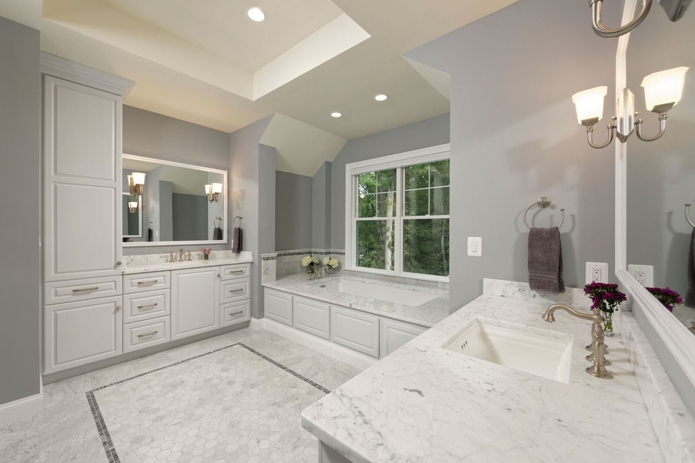 Design ideas for a large contemporary ensuite bathroom in DC Metro with raised-panel cabinets, white cabinets, a submerged bath, grey walls, marble flooring, a submerged sink, granite worktops and grey floors.