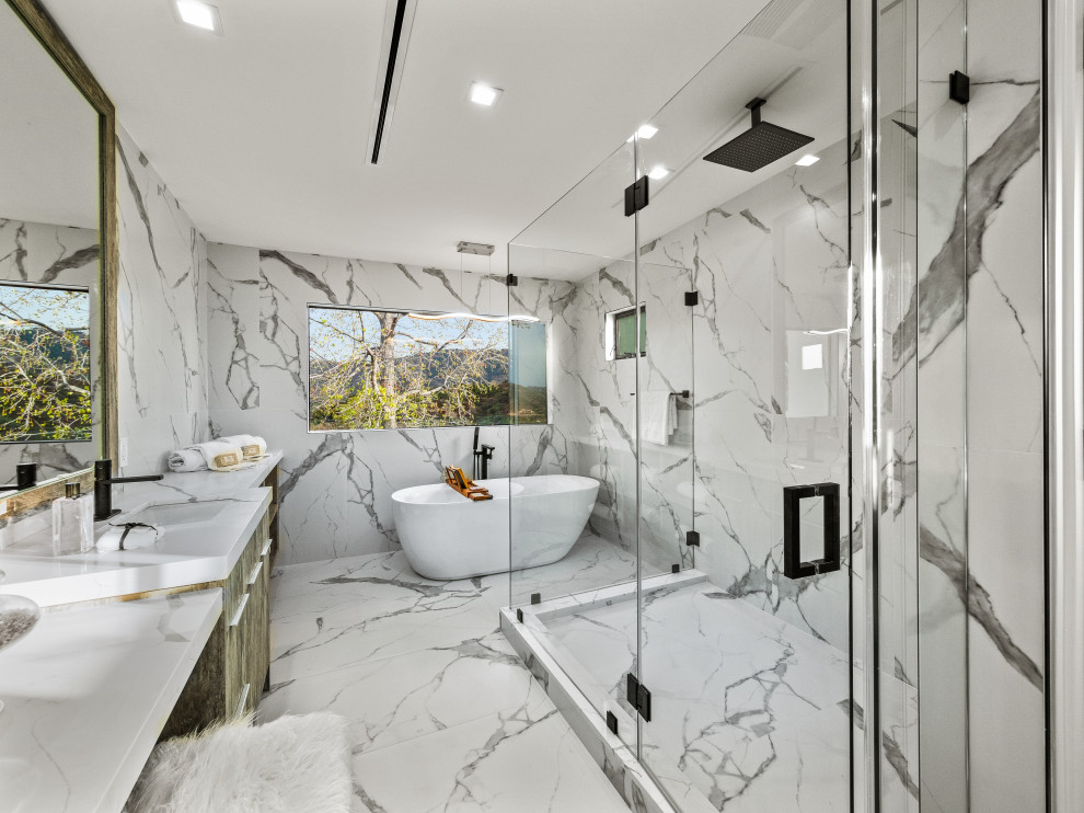 Example of a trendy white tile white floor and single-sink freestanding bathtub design in Los Angeles with flat-panel cabinets, dark wood cabinets, an undermount sink, white countertops and a built-in vanity