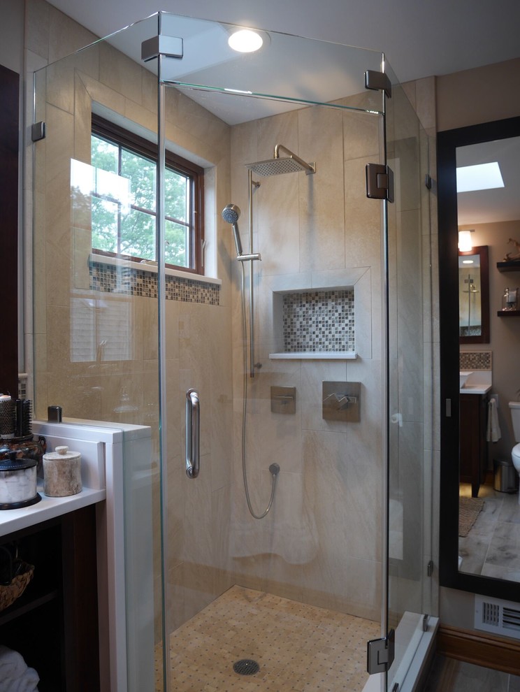 Corner shower - small transitional master gray tile and ceramic tile ceramic tile corner shower idea in New York with shaker cabinets, dark wood cabinets, a two-piece toilet, beige walls, a vessel sink and quartz countertops
