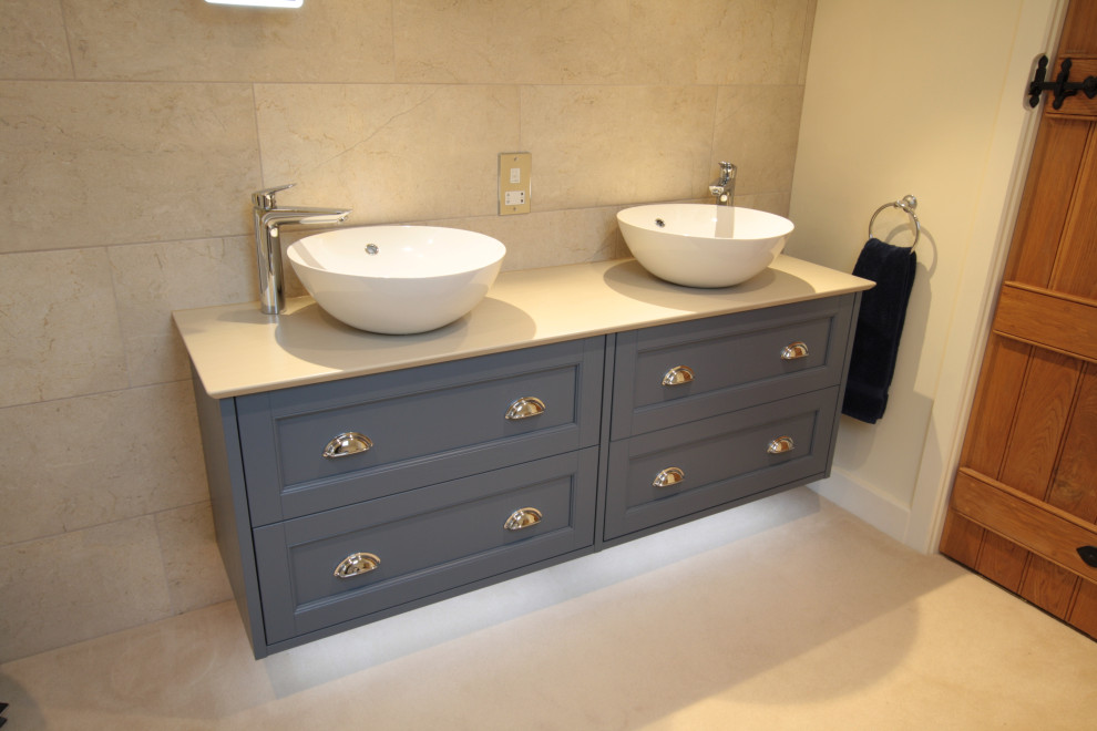 Bathroom - large contemporary master ceramic tile bathroom idea in Oxfordshire with blue cabinets, a vessel sink, solid surface countertops and a hinged shower door
