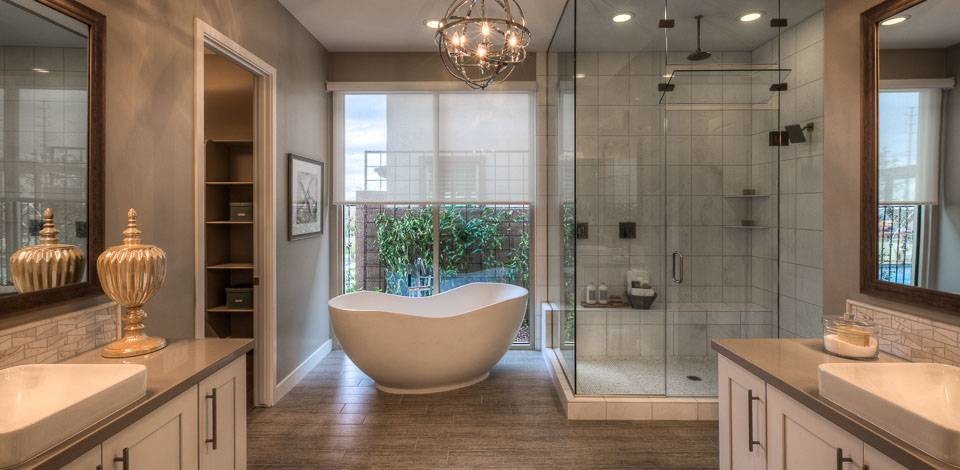 Freestanding bathtub - large transitional master gray tile ceramic tile freestanding bathtub idea in Phoenix with a drop-in sink, shaker cabinets, white cabinets, quartzite countertops and gray walls