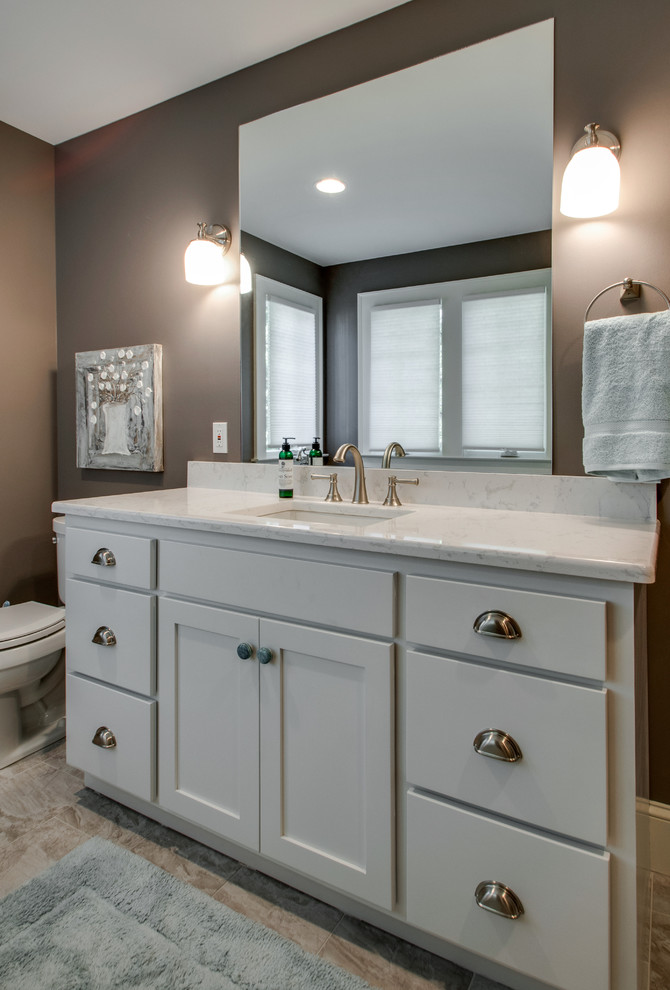 Photo of a medium sized classic ensuite bathroom in Nashville with a submerged sink, shaker cabinets, grey cabinets, engineered stone worktops, a freestanding bath, an alcove shower, a two-piece toilet, grey tiles, porcelain tiles, brown walls and ceramic flooring.