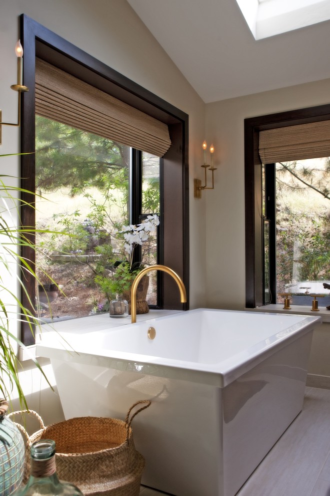 Design ideas for a world-inspired ensuite bathroom in Other with dark wood cabinets and a freestanding bath.