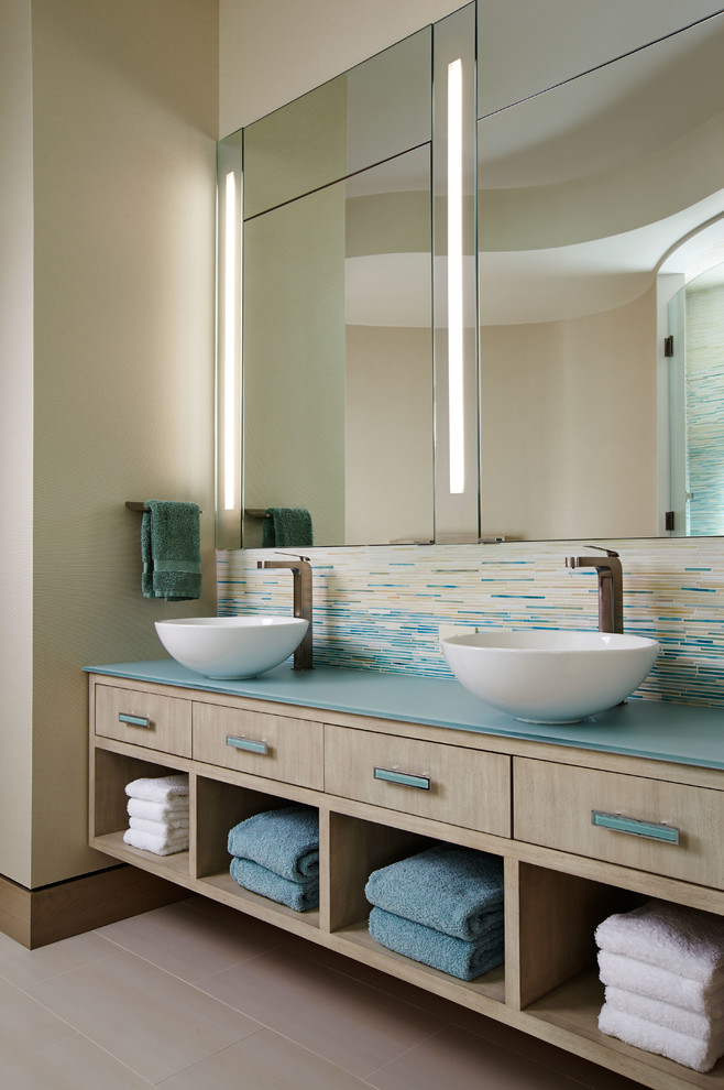 Large contemporary ensuite bathroom in Wichita with a vessel sink, light wood cabinets, multi-coloured tiles, mosaic tiles, beige walls, a freestanding bath, flat-panel cabinets, blue worktops, porcelain flooring and beige floors.