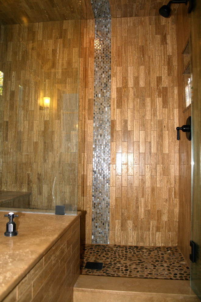 Doorless shower - large master brown tile and stone tile travertine floor doorless shower idea in Santa Barbara with a vessel sink, furniture-like cabinets, dark wood cabinets, an undermount tub, a one-piece toilet, blue walls and solid surface countertops
