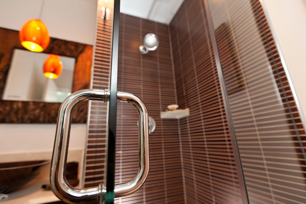 Diseño de cuarto de baño asiático con lavabo sobreencimera, ducha esquinera, baldosas y/o azulejos marrones, baldosas y/o azulejos en mosaico y paredes blancas