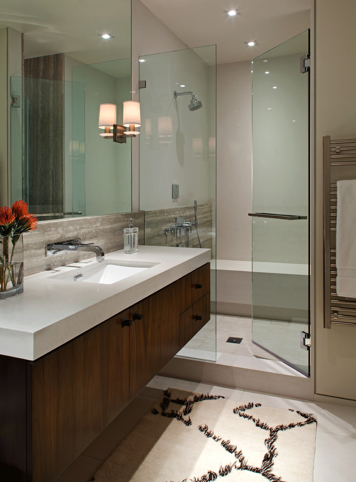 Example of a mid-sized trendy master porcelain tile alcove shower design in San Diego with an undermount sink, flat-panel cabinets, dark wood cabinets, quartz countertops and white walls