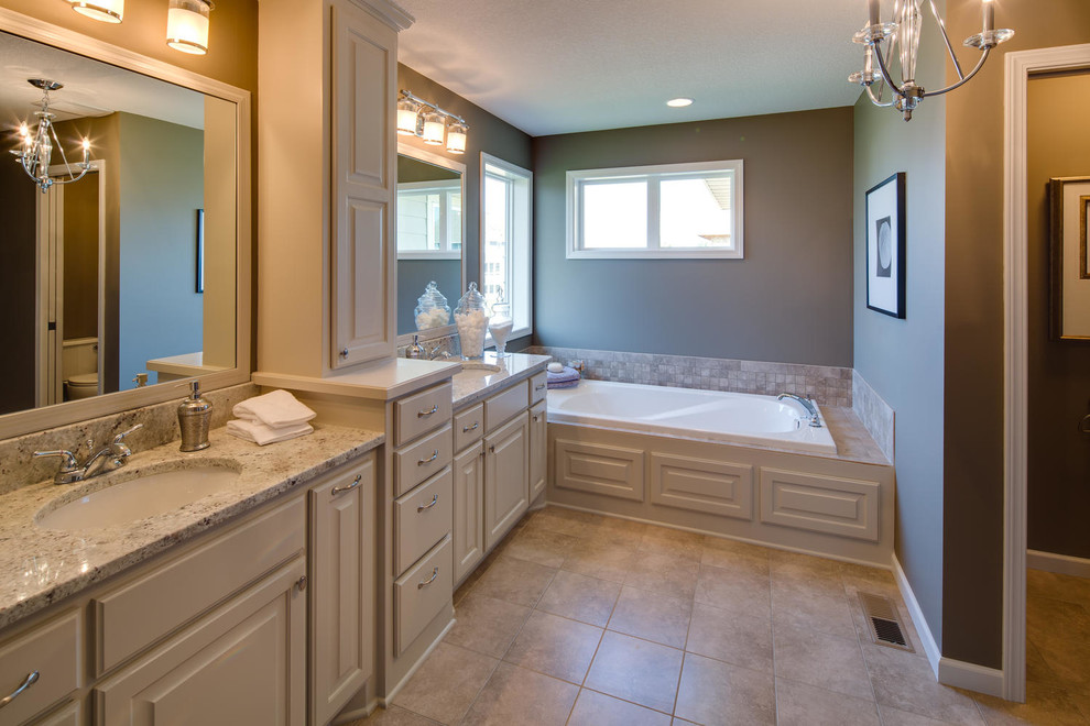 Transitional bathroom photo in Minneapolis with an undermount sink, raised-panel cabinets, white cabinets and granite countertops