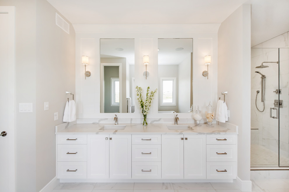 Inspiration for a large timeless master porcelain tile and white floor bathroom remodel in Other with shaker cabinets, white cabinets, beige walls, an undermount sink, quartzite countertops, a hinged shower door and white countertops