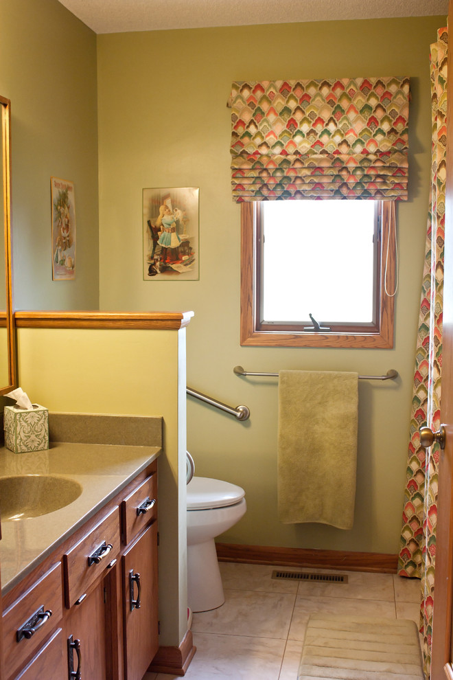 Example of a mid-sized classic vinyl floor bathroom design in Wichita with green walls and solid surface countertops