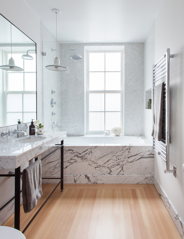 Example of a mid-sized trendy master white tile and marble tile light wood floor, single-sink and beige floor bathroom design in New York with white cabinets, white walls, a drop-in sink, marble countertops, white countertops and a built-in vanity