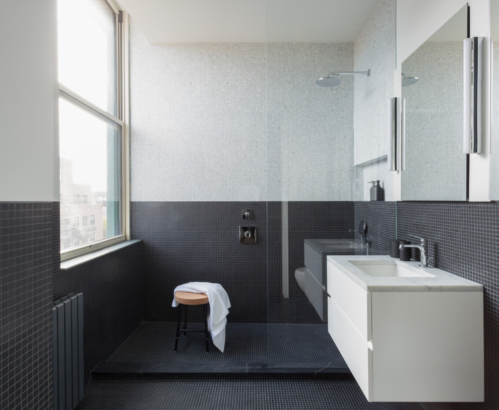 Design ideas for a medium sized contemporary ensuite bathroom in New York with flat-panel cabinets, white cabinets, white walls, a built-in sink, black floors, an open shower, a walk-in shower, black tiles, marble worktops, white worktops and a floating vanity unit.