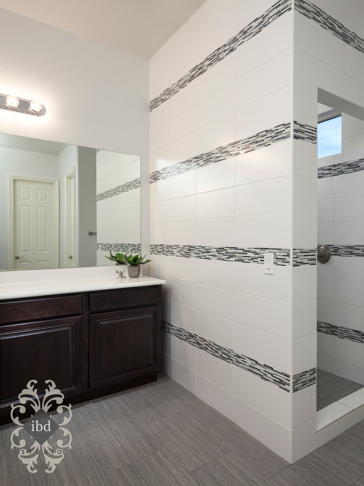 Inspiration for a mid-sized transitional master white tile and ceramic tile ceramic tile alcove shower remodel in Phoenix with raised-panel cabinets, dark wood cabinets, solid surface countertops and gray walls