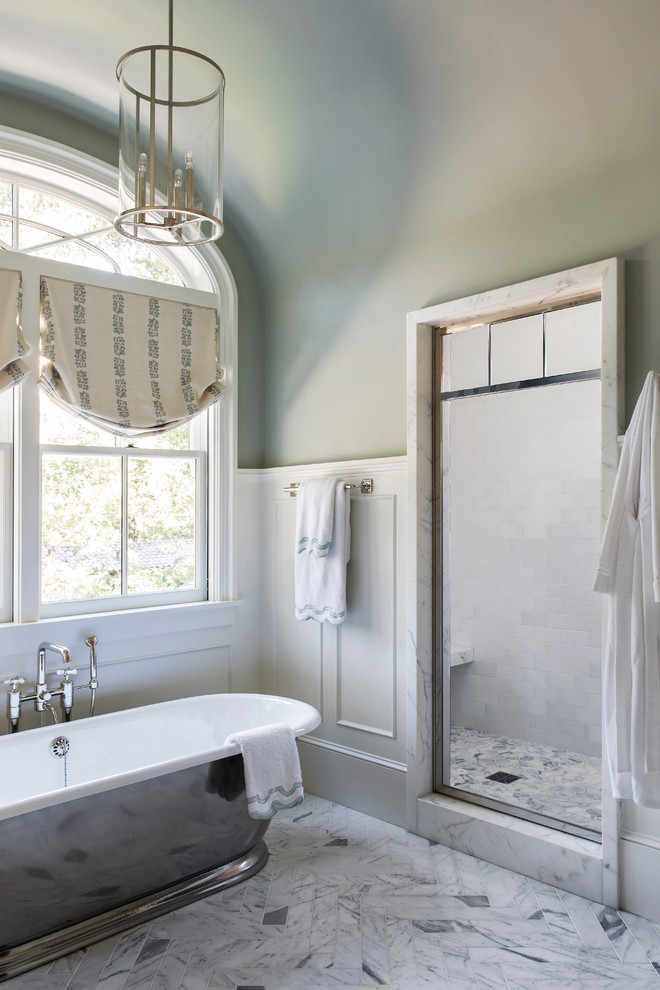 На фото: главная ванная комната среднего размера в стиле неоклассика (современная классика) с отдельно стоящей ванной, душем в нише, серой плиткой, серыми стенами, полом из керамогранита, разноцветным полом и открытым душем с