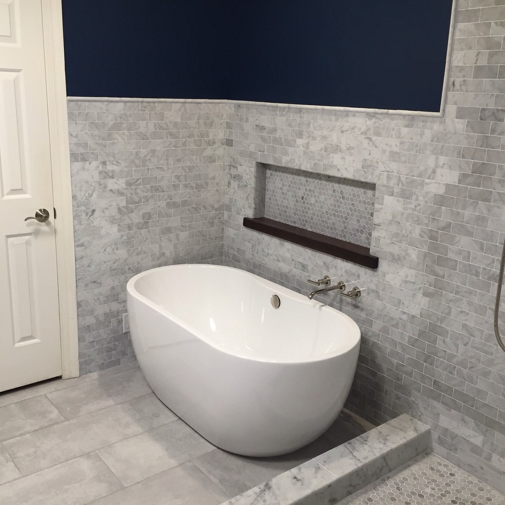 Ispirazione per una stanza da bagno padronale moderna di medie dimensioni con ante con riquadro incassato, ante in legno bruno, vasca freestanding, doccia ad angolo, piastrelle in pietra e pareti blu